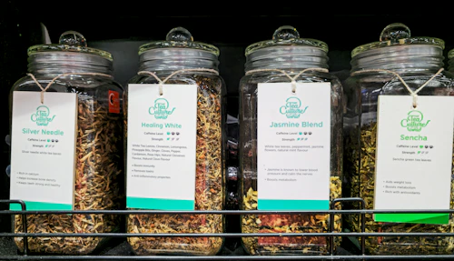 glass jars filled with dried herbs and spices