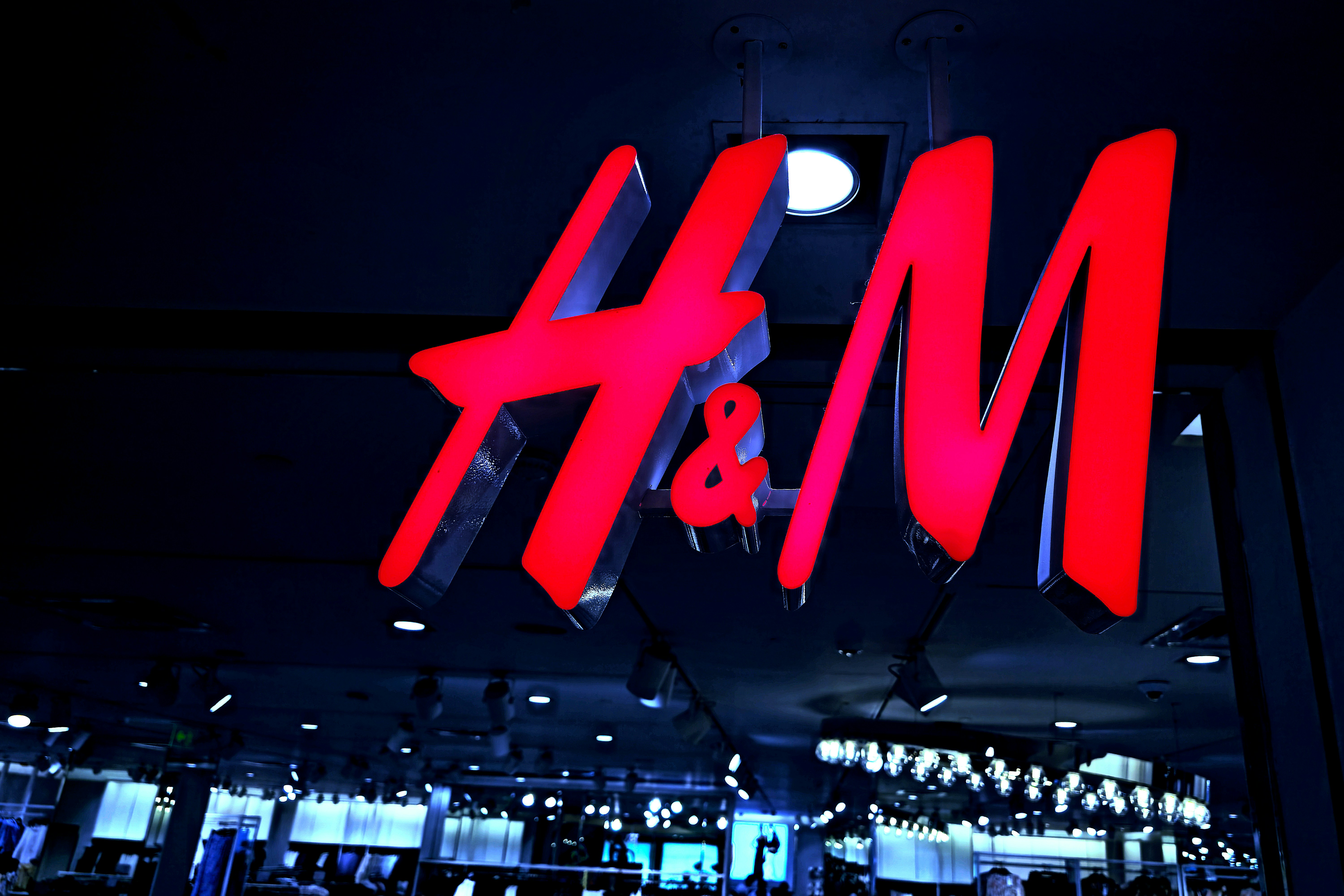 Red h&m logo illuminated at night