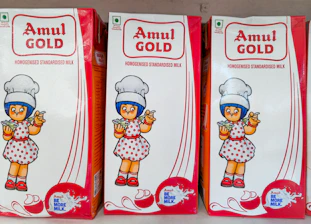 Three cartons of amul gold condensed milk.