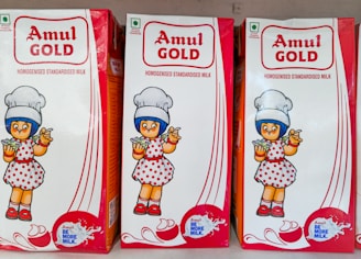 Three cartons of amul gold condensed milk.