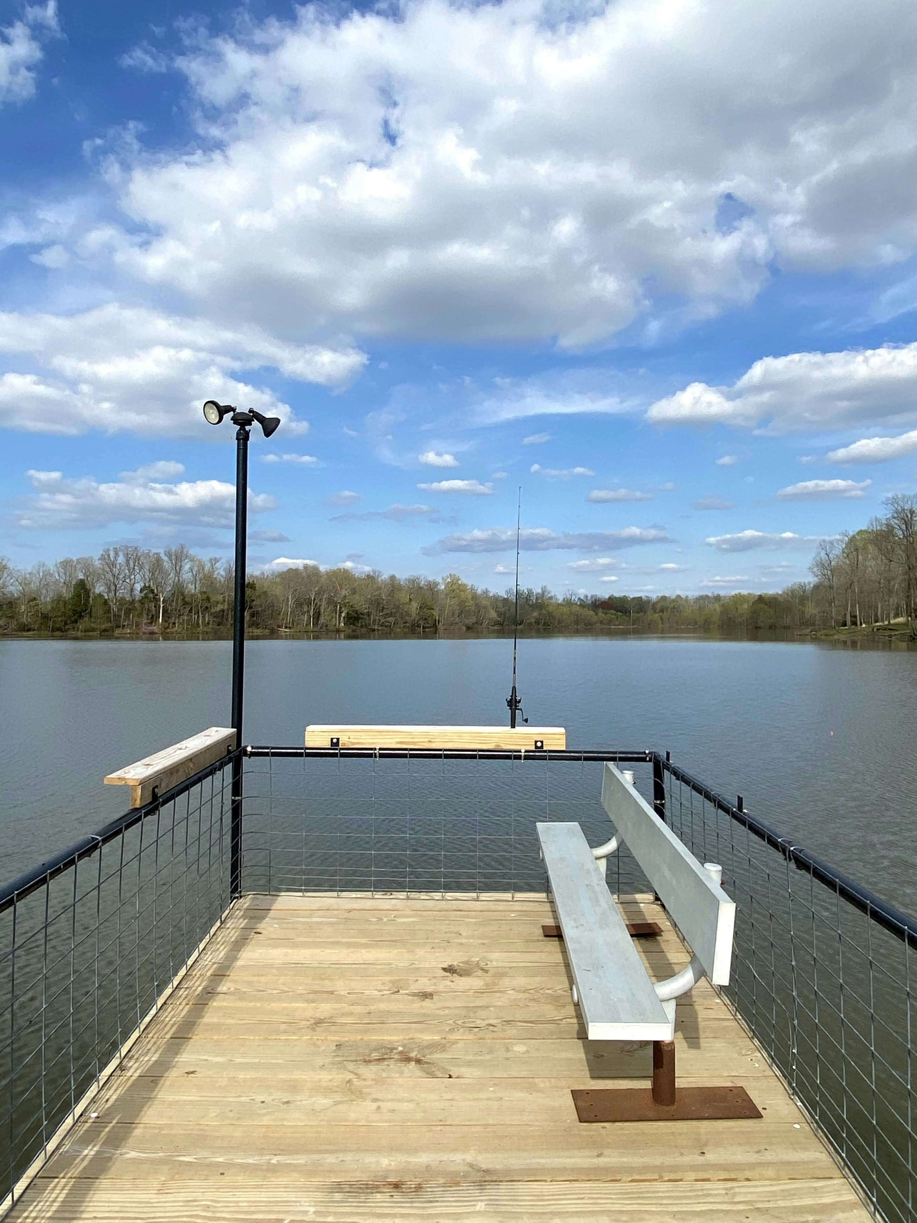 Wooden dock with benches overlooking a calm lake
