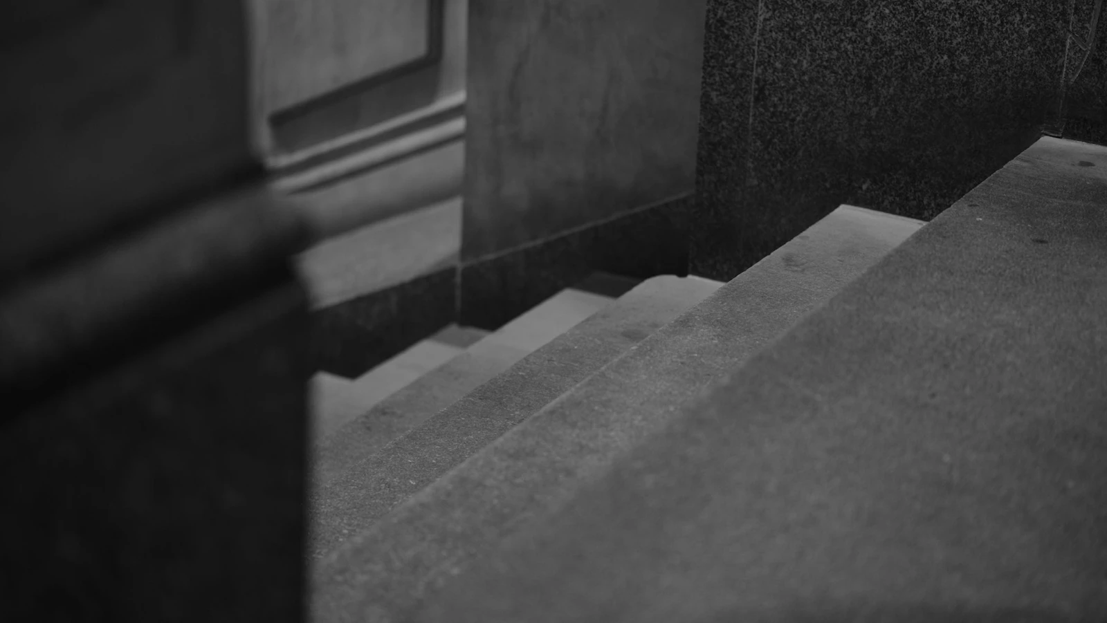 A concrete staircase descending into darkness