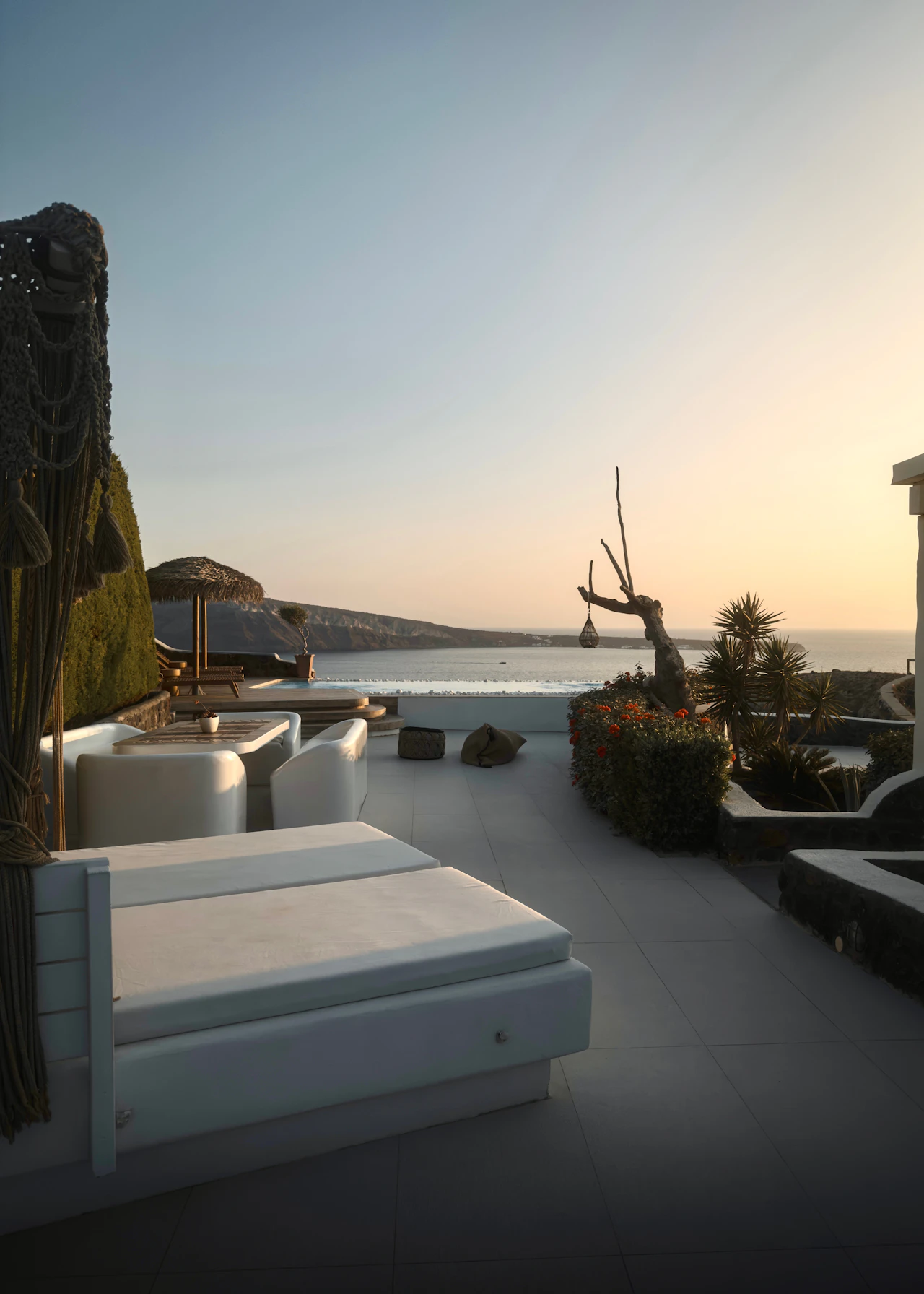 Luxury villa with private infinity pool overlooking the sea at sunset in Santorini, Greece, under full property management by Icarus Management
