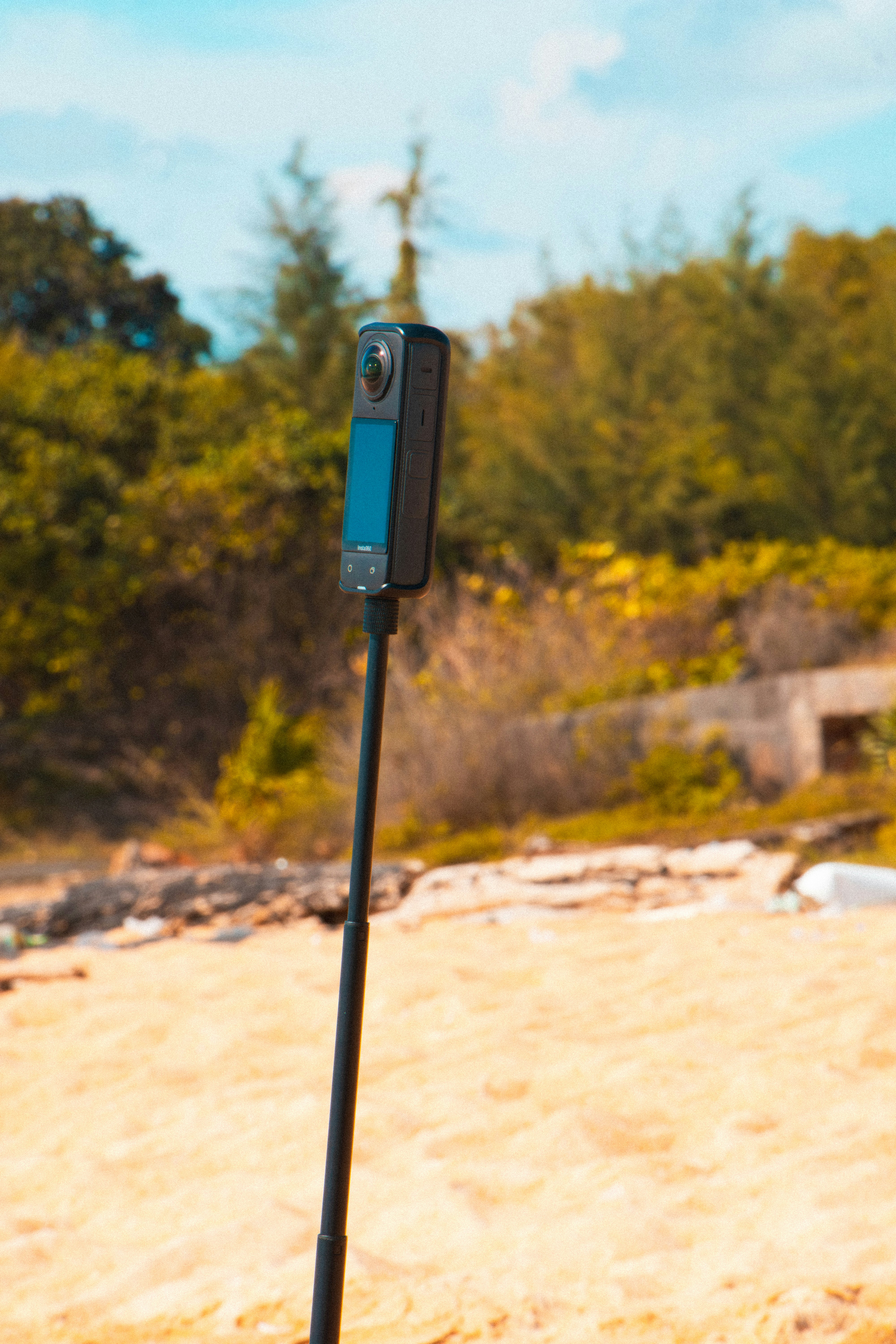 360 camera on a selfie stick on the beach.