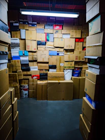 A room filled with many stacked cardboard boxes.