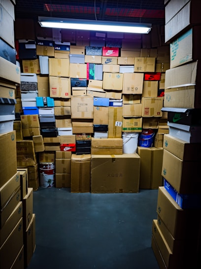 A room filled with many stacked cardboard boxes.
