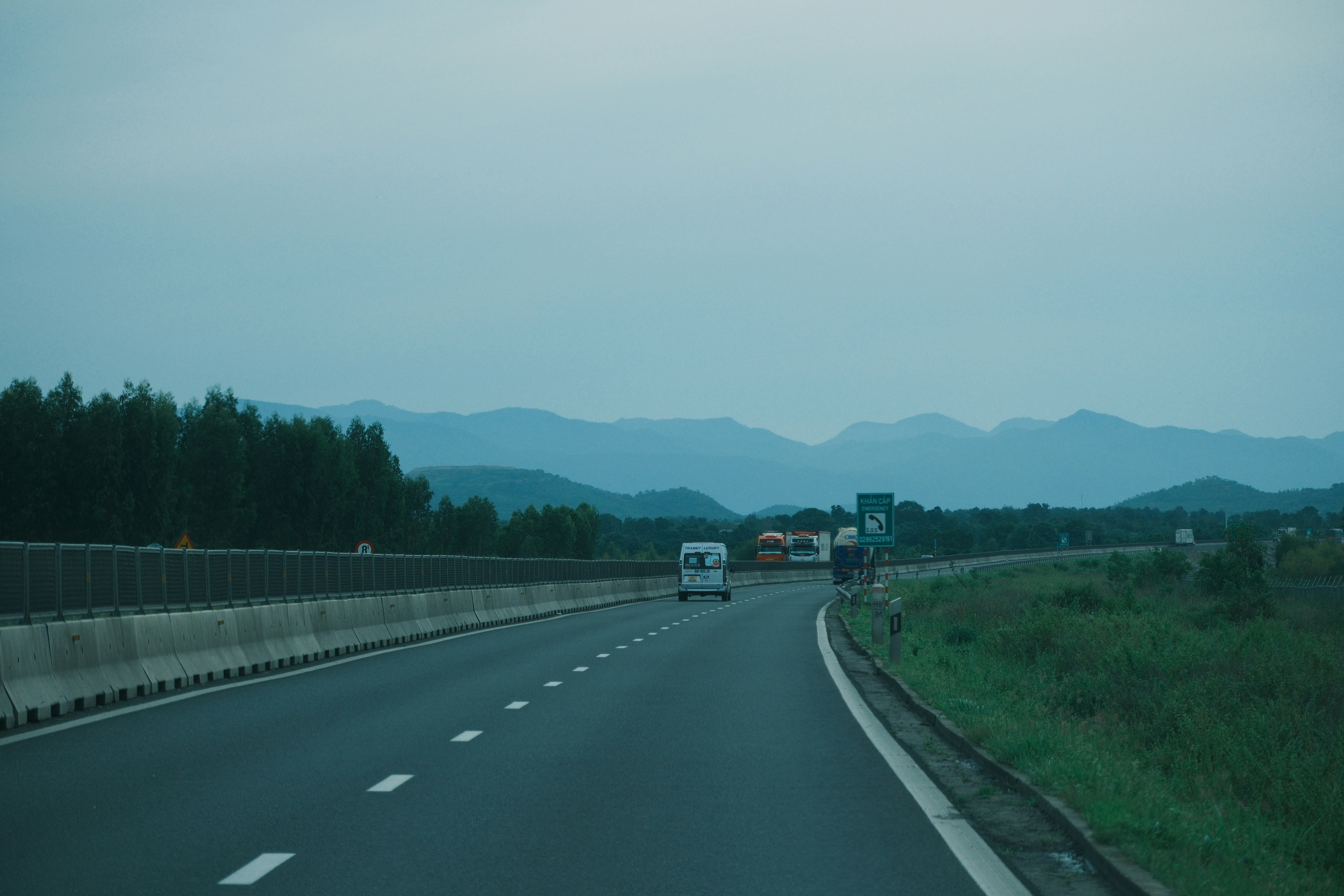 Highway with distant mountains and trees