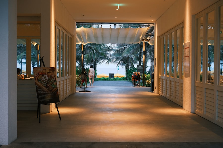 A tropical veranda with warm lighting opening toward palm trees and garden