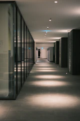 Modern hallway with illuminated floor and glass walls