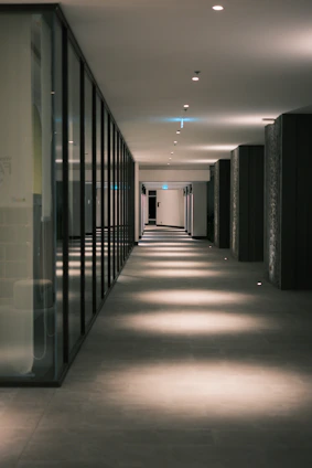 Modern hallway with illuminated floor and glass walls