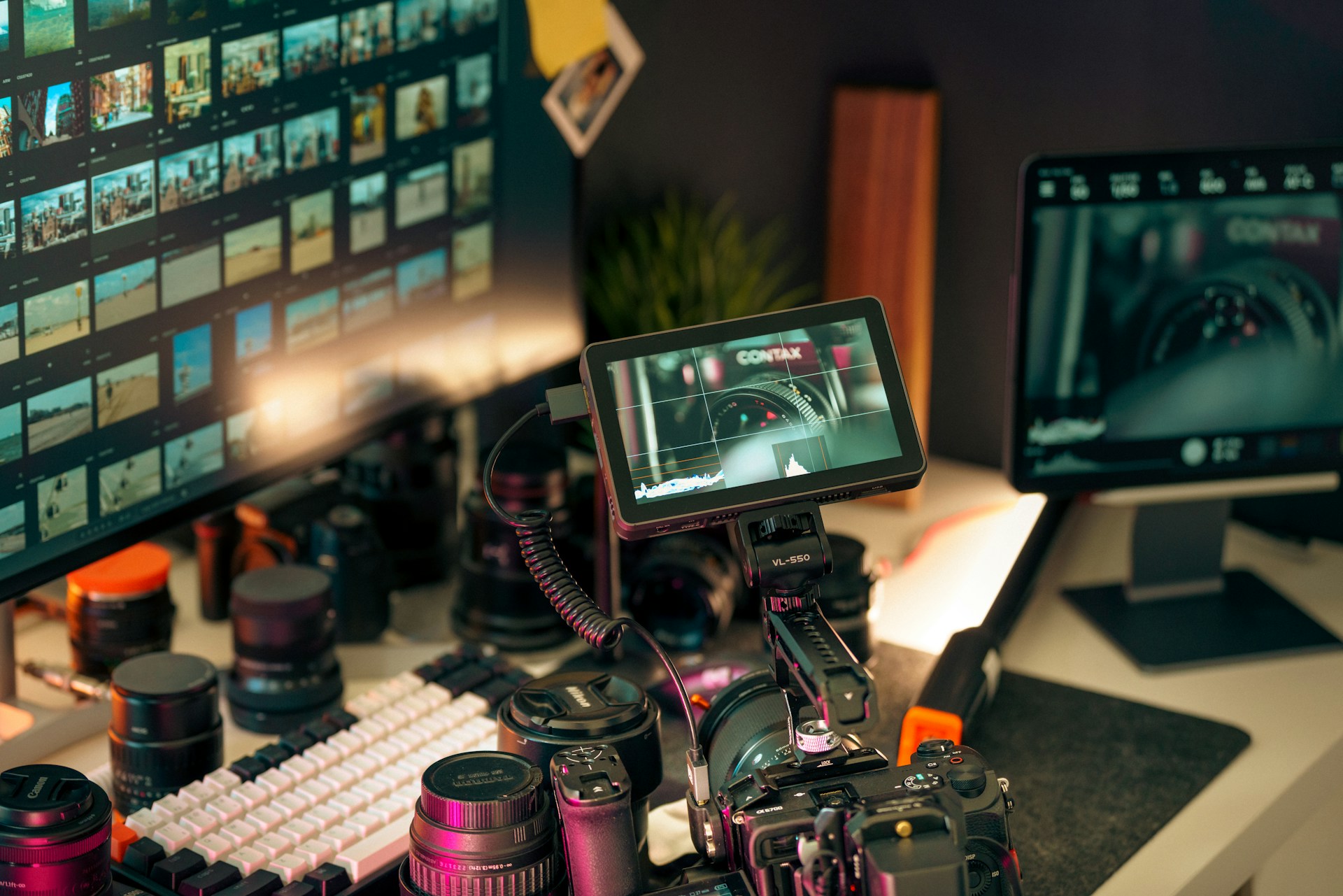 Filmmaker's setup with cameras, lenses, and monitors