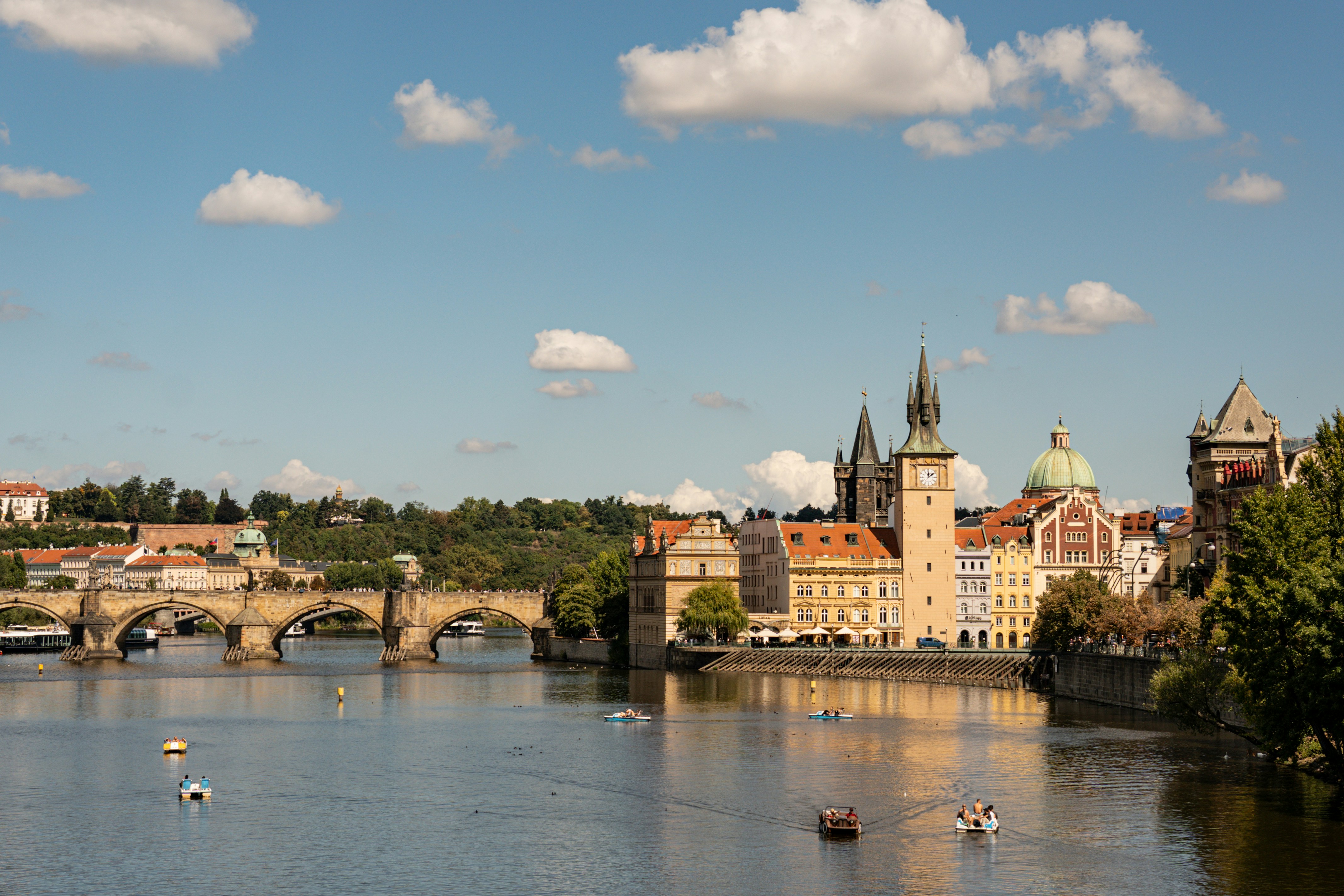 Charles bridge and prague cityscape across the vltava river.