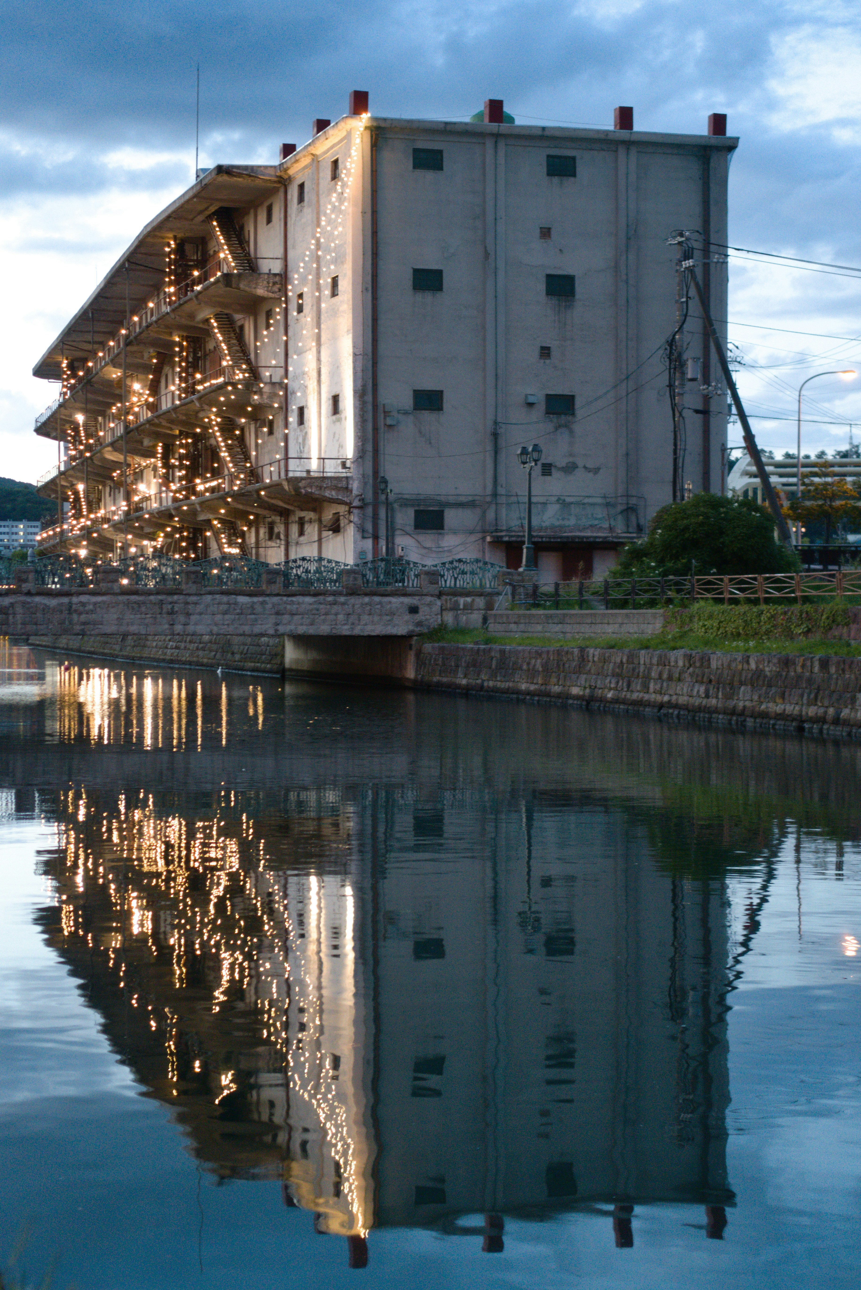 Old industrial building reflected in calm water