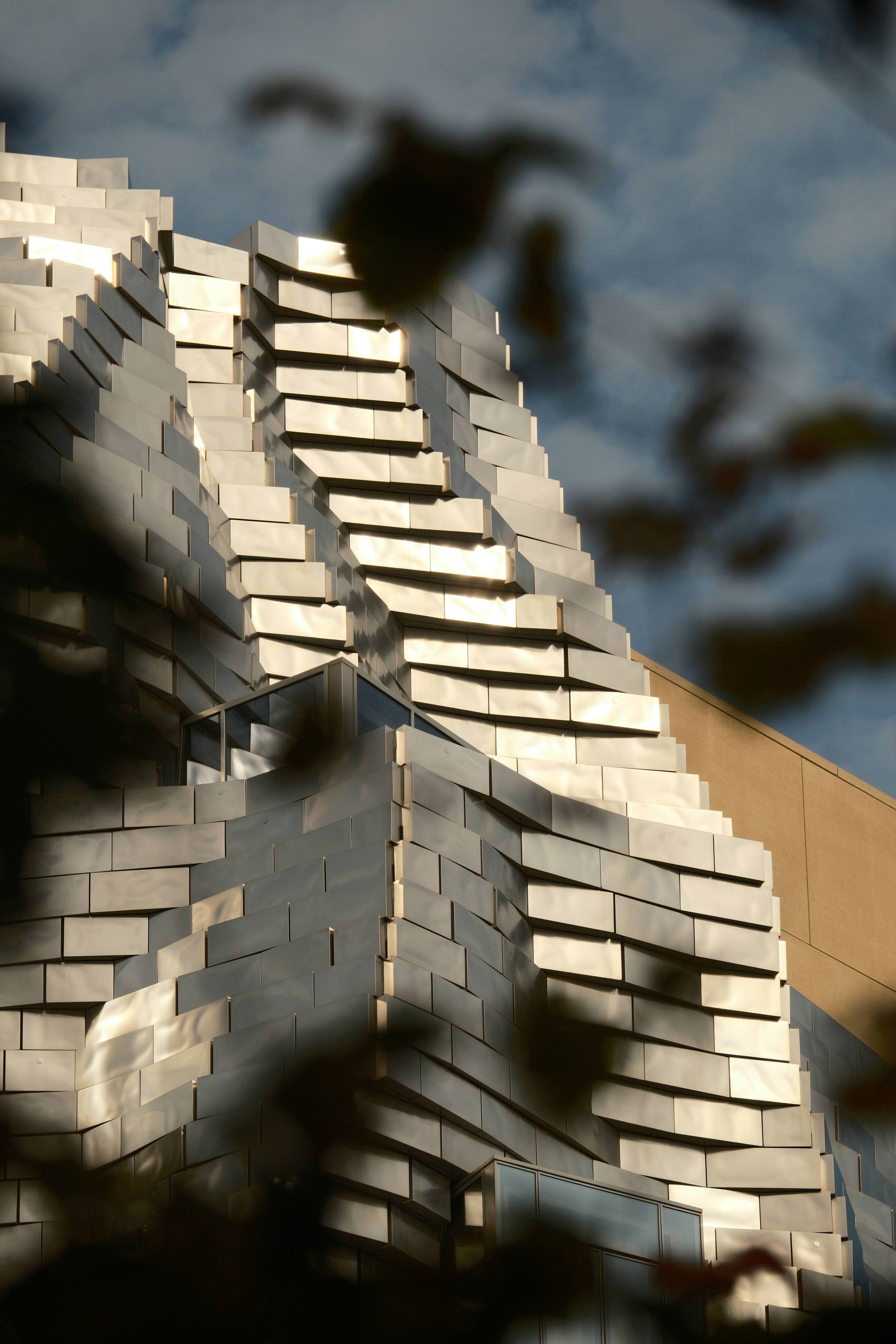 Modern building with metallic, layered facade.