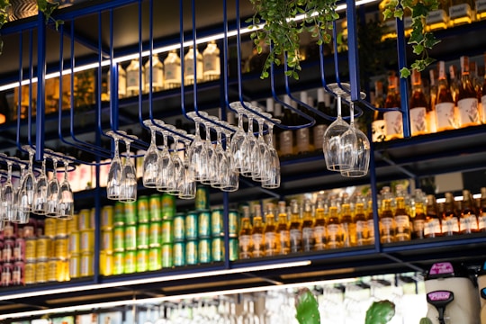 Shelves stocked with bottles, cans, and glasses.