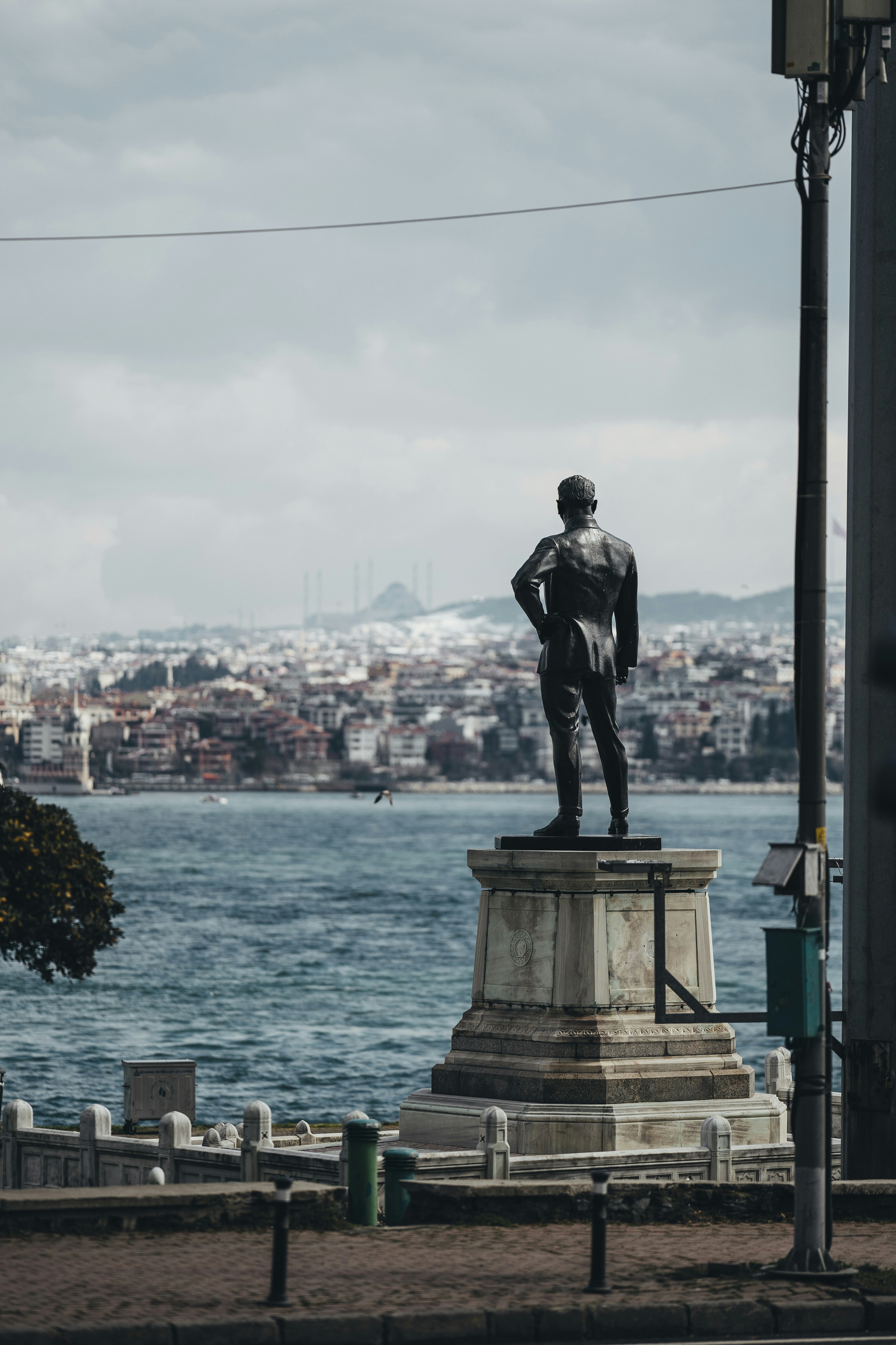 Statue overlooking a city and bay