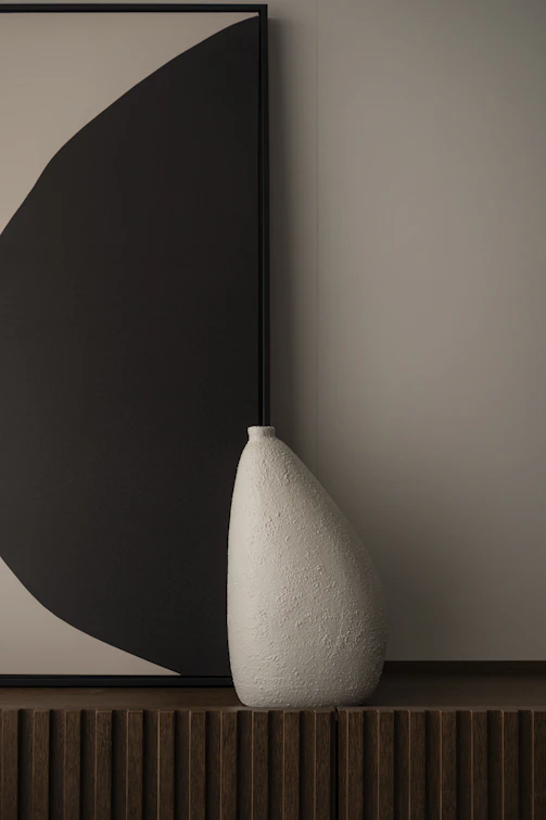 Textured white vase against abstract art