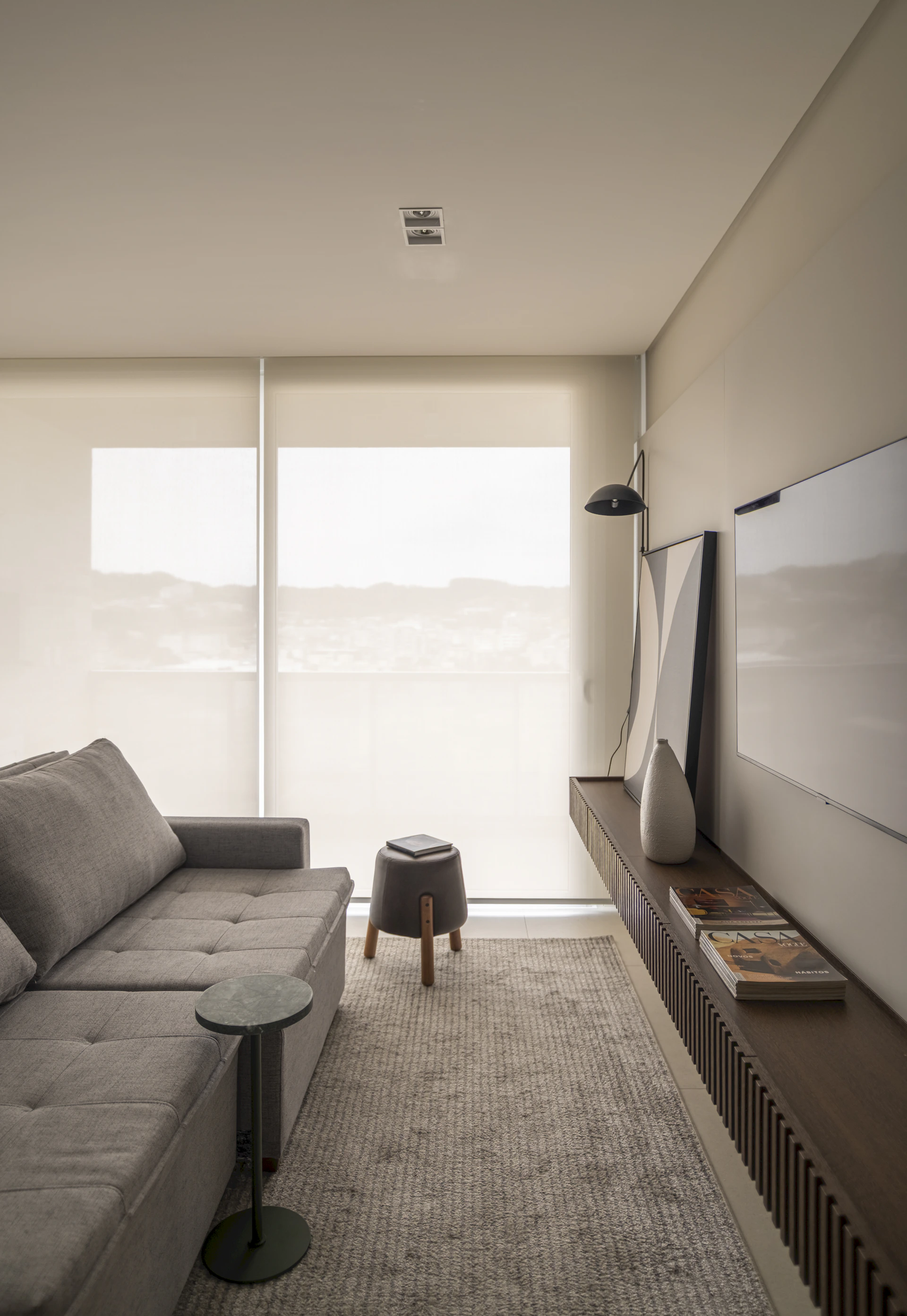 Modern living room with gray sectional sofa and tv.