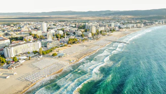 Coastal city with a long sandy beach and turquoise ocean.