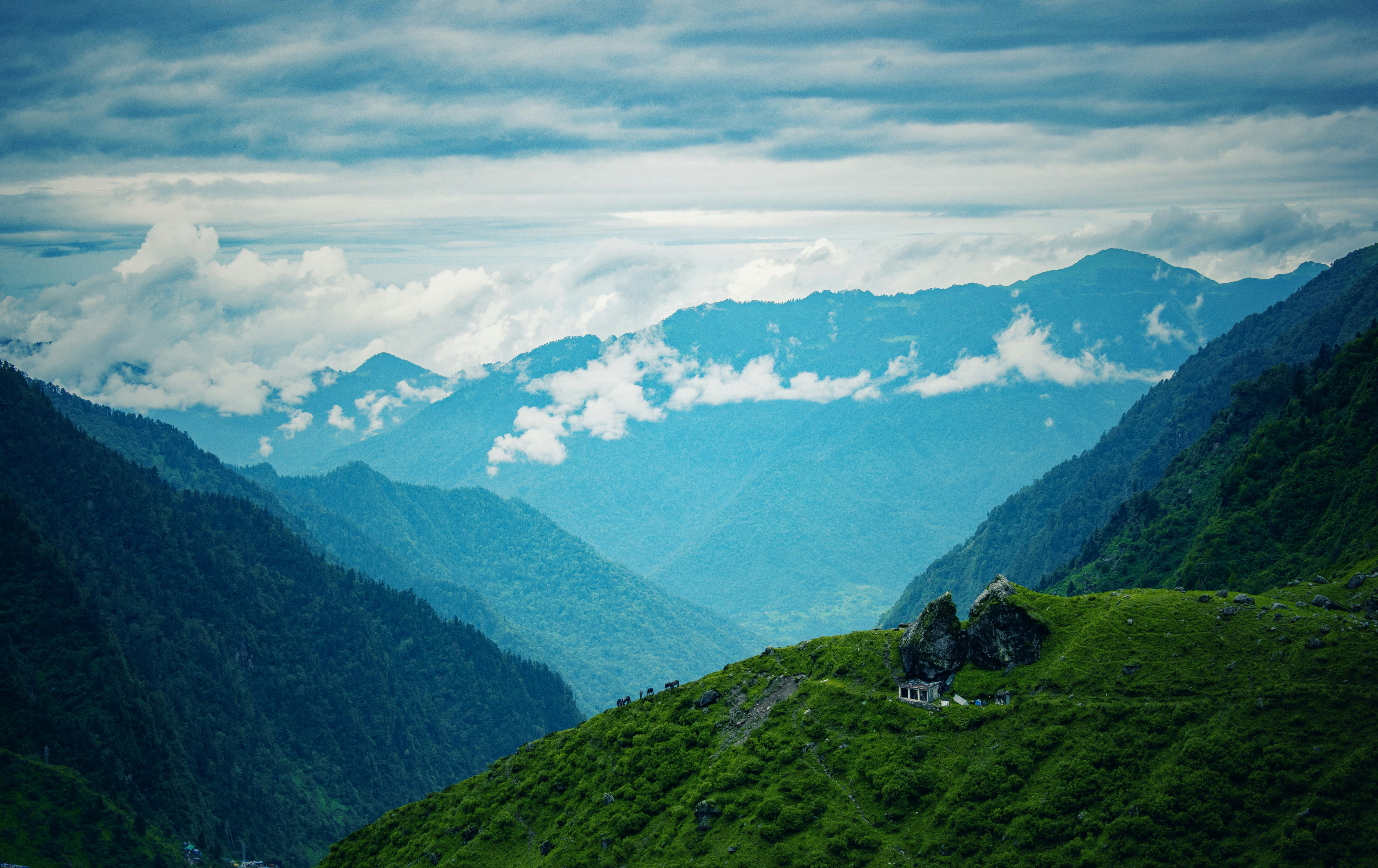 Scenic Himalayan mountain landscape with green hills and mist