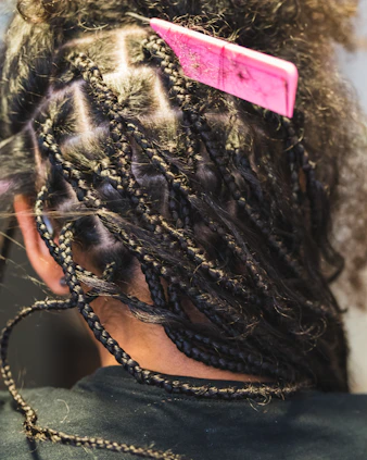 A person getting box braids done