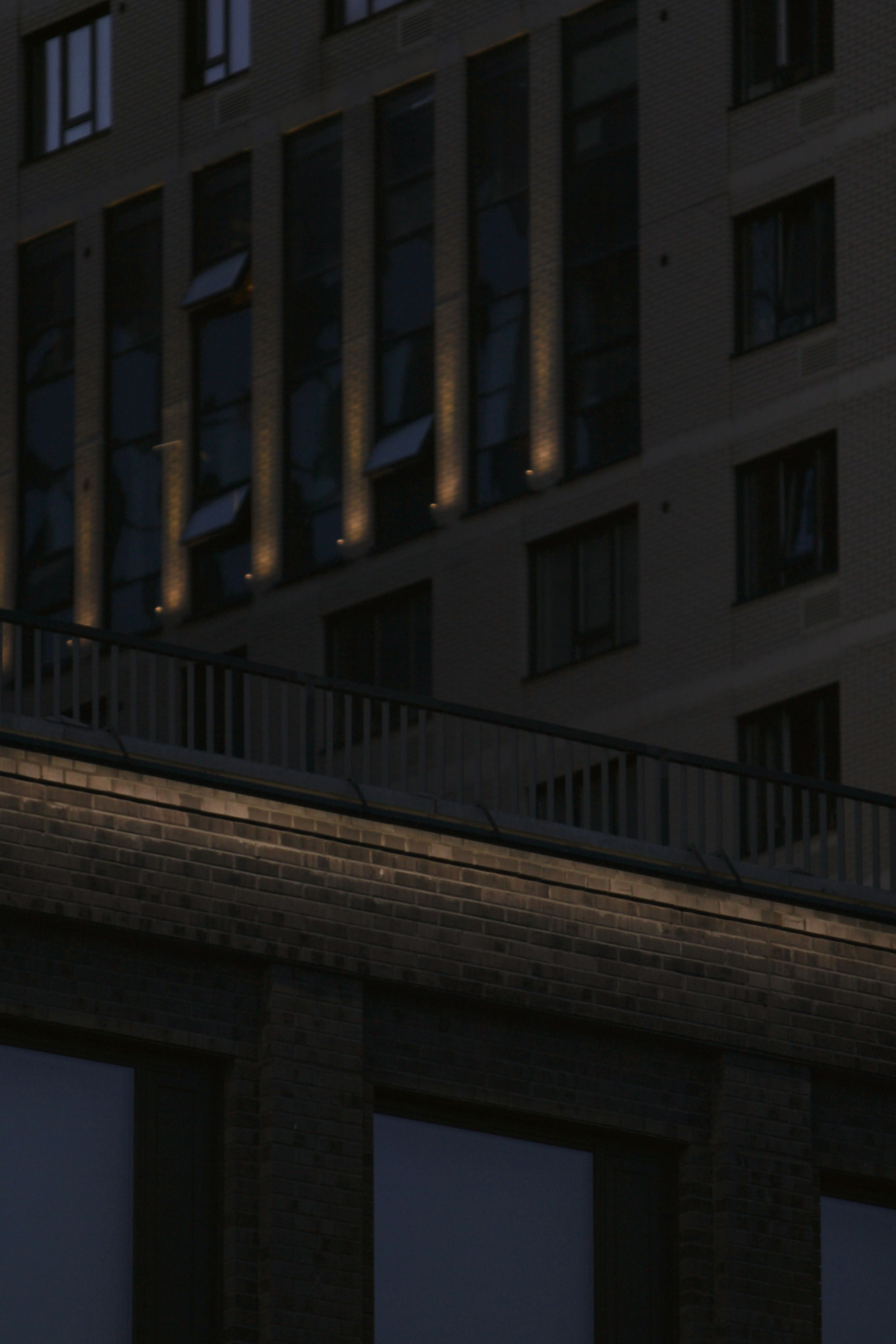 Modern buildings with illuminated windows at dusk.