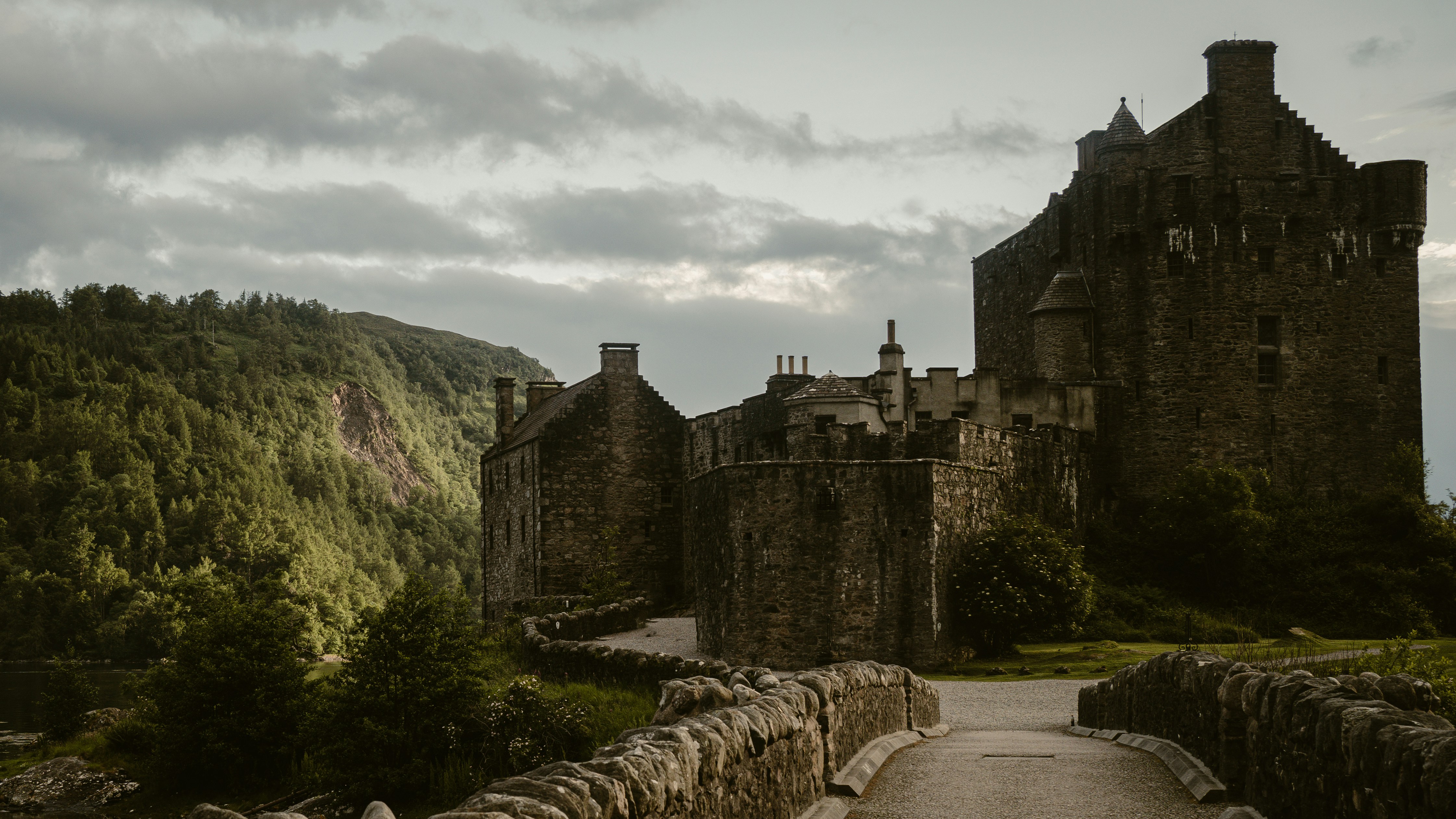 Stone castle on a hill with a bridge
