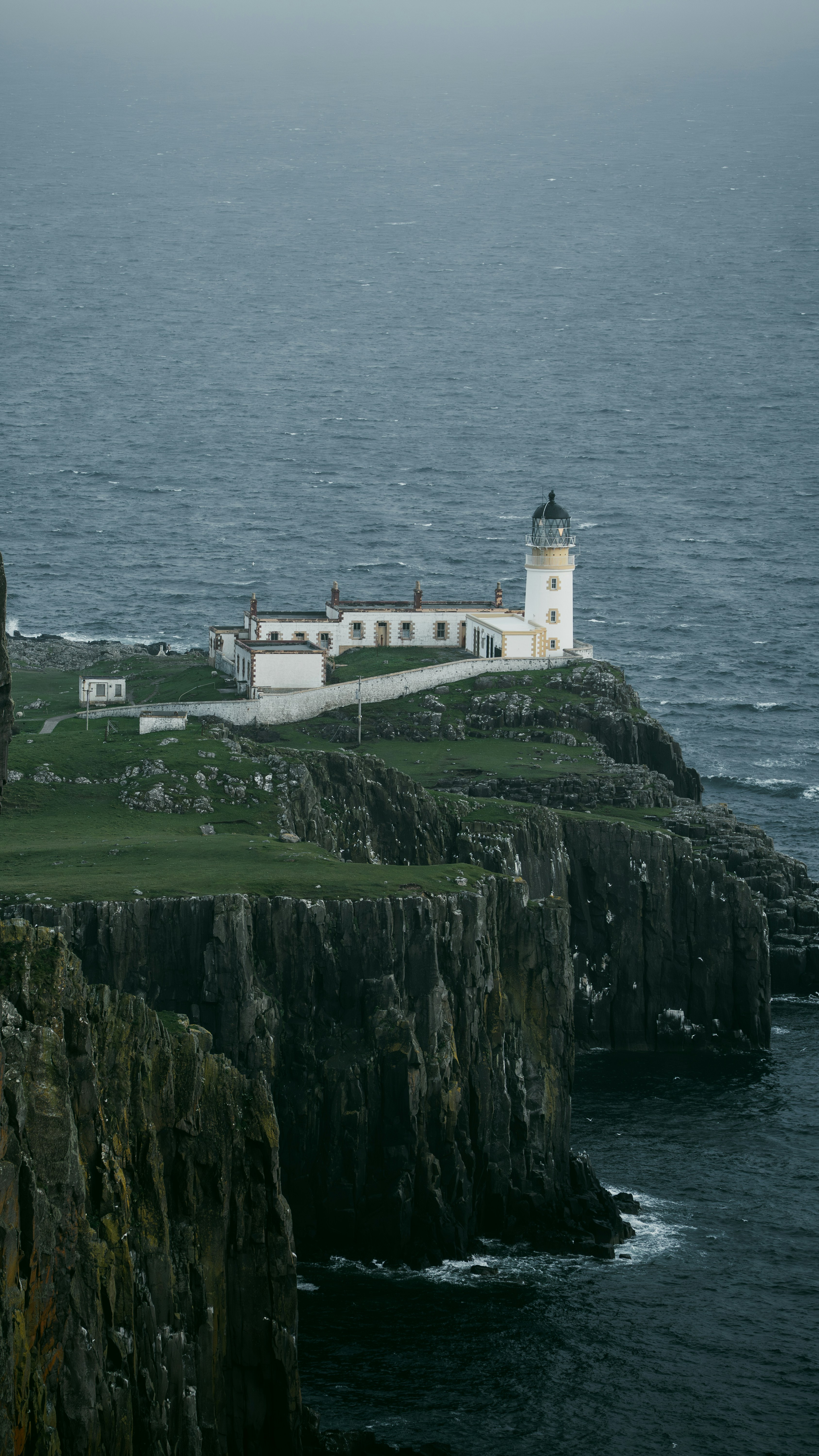 Lighthouse on a cliff overlooking a stormy sea