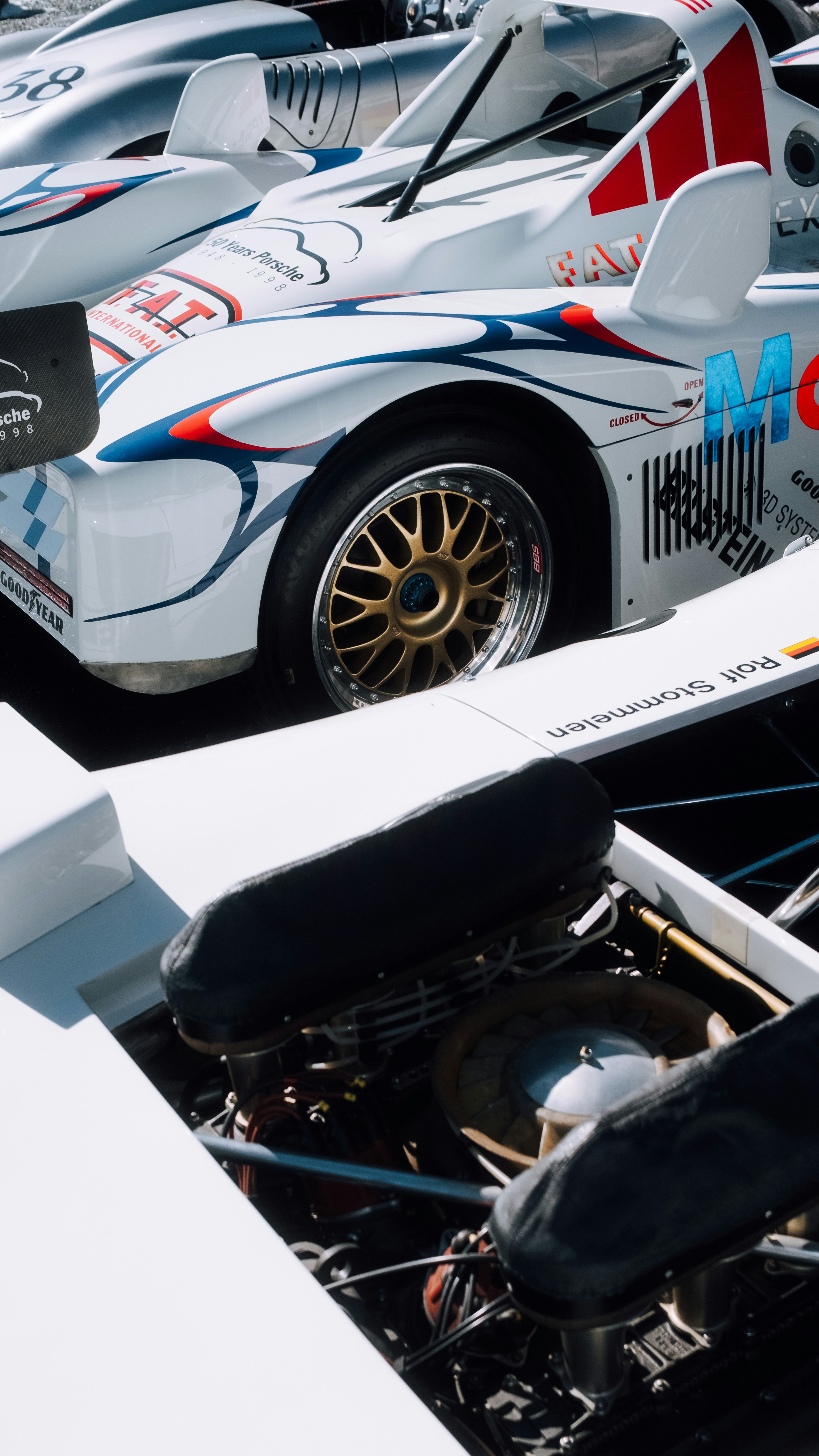 White racing cars with detailed engines and wheels.