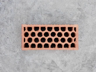 A single hollow brick on a concrete surface
