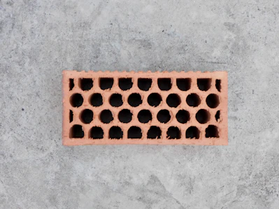 A single hollow brick on a concrete surface