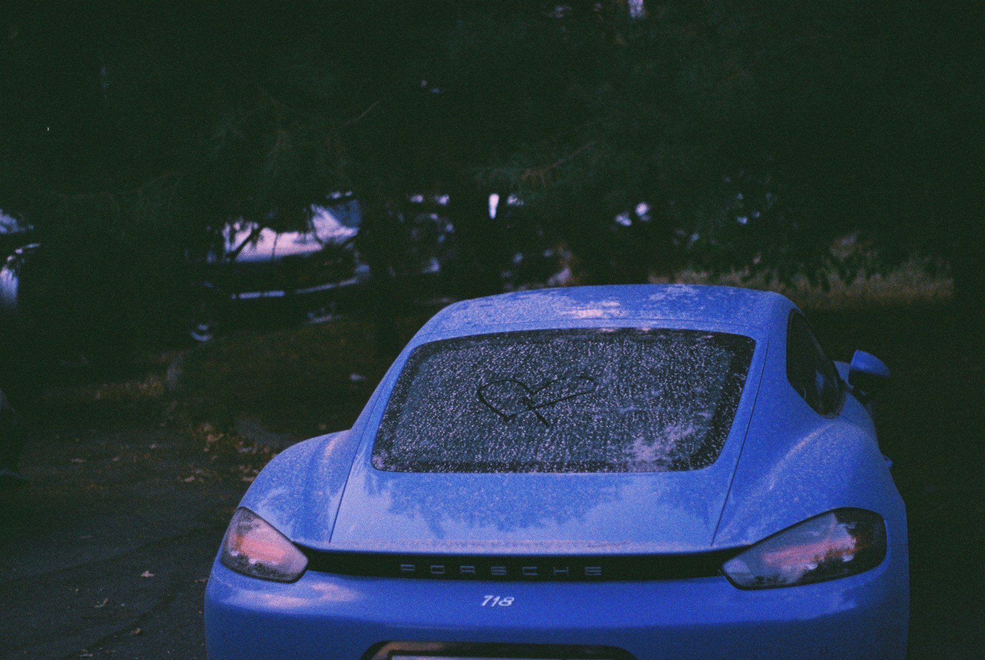 Blue sports car with rain on the windshield