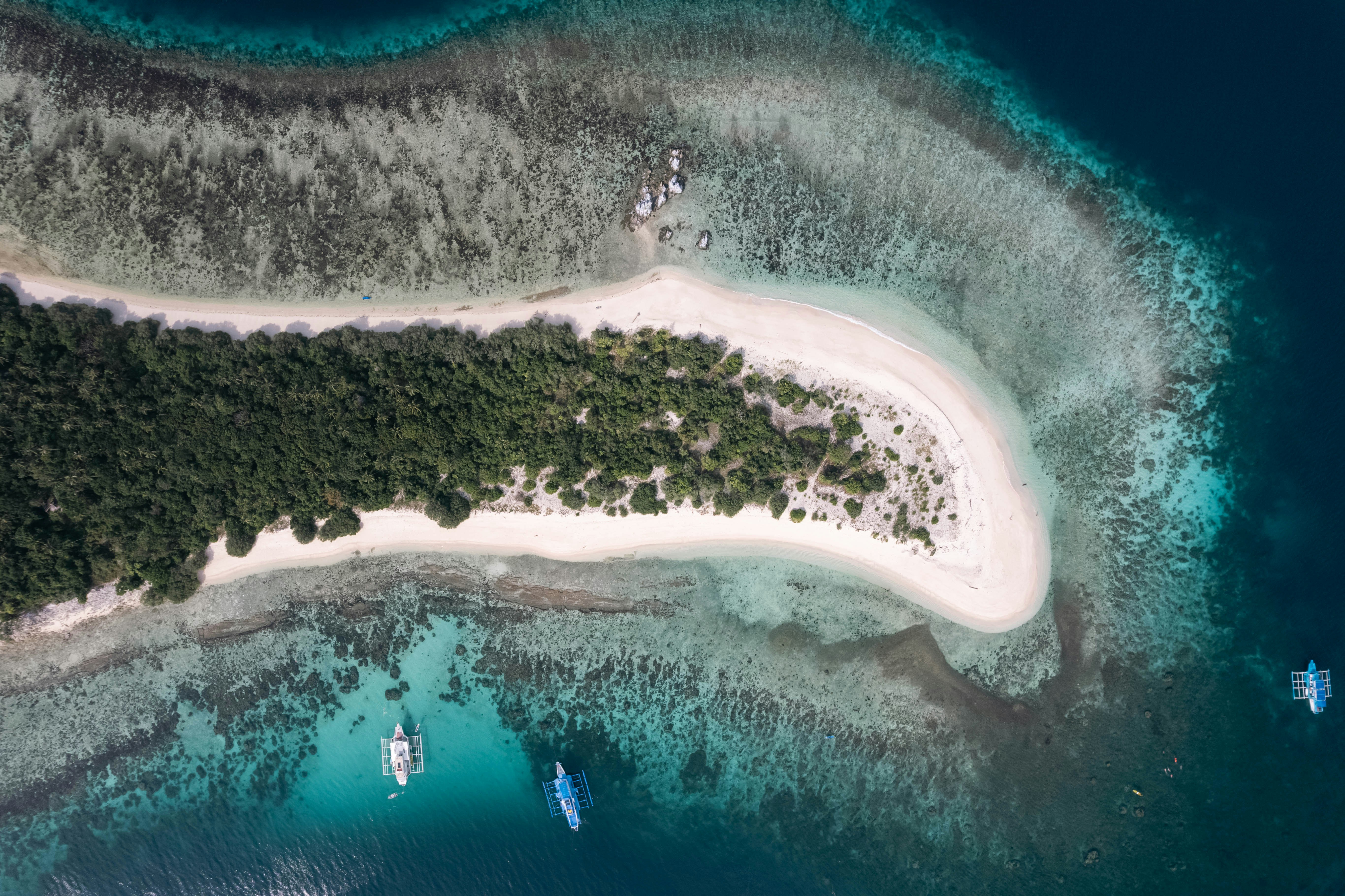 Aerial view of a tropical island with white sand beach.