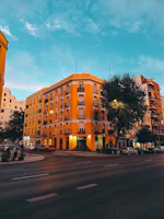 Orange building on a city street at dusk