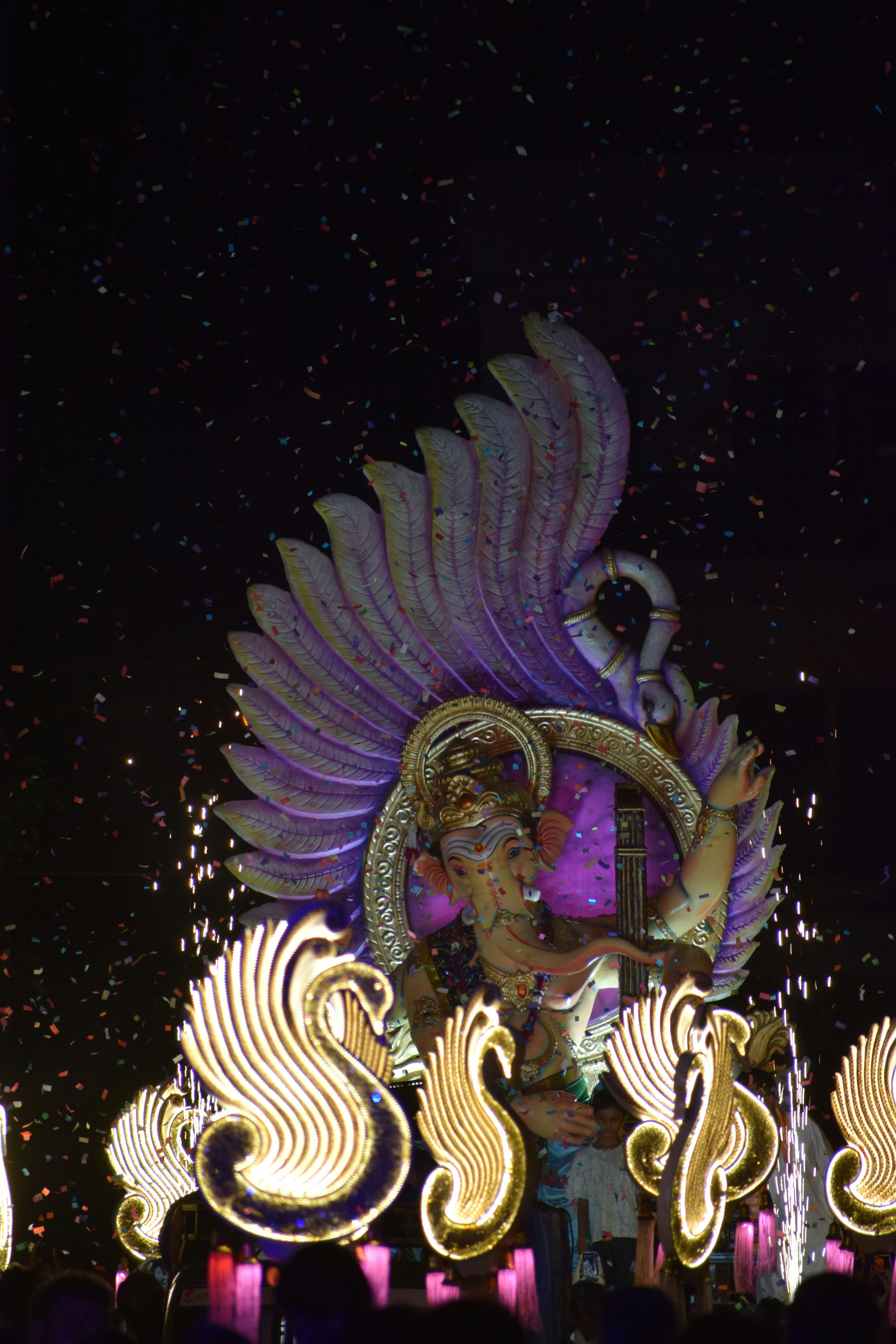 Ganesha statue illuminated with lights and fireworks