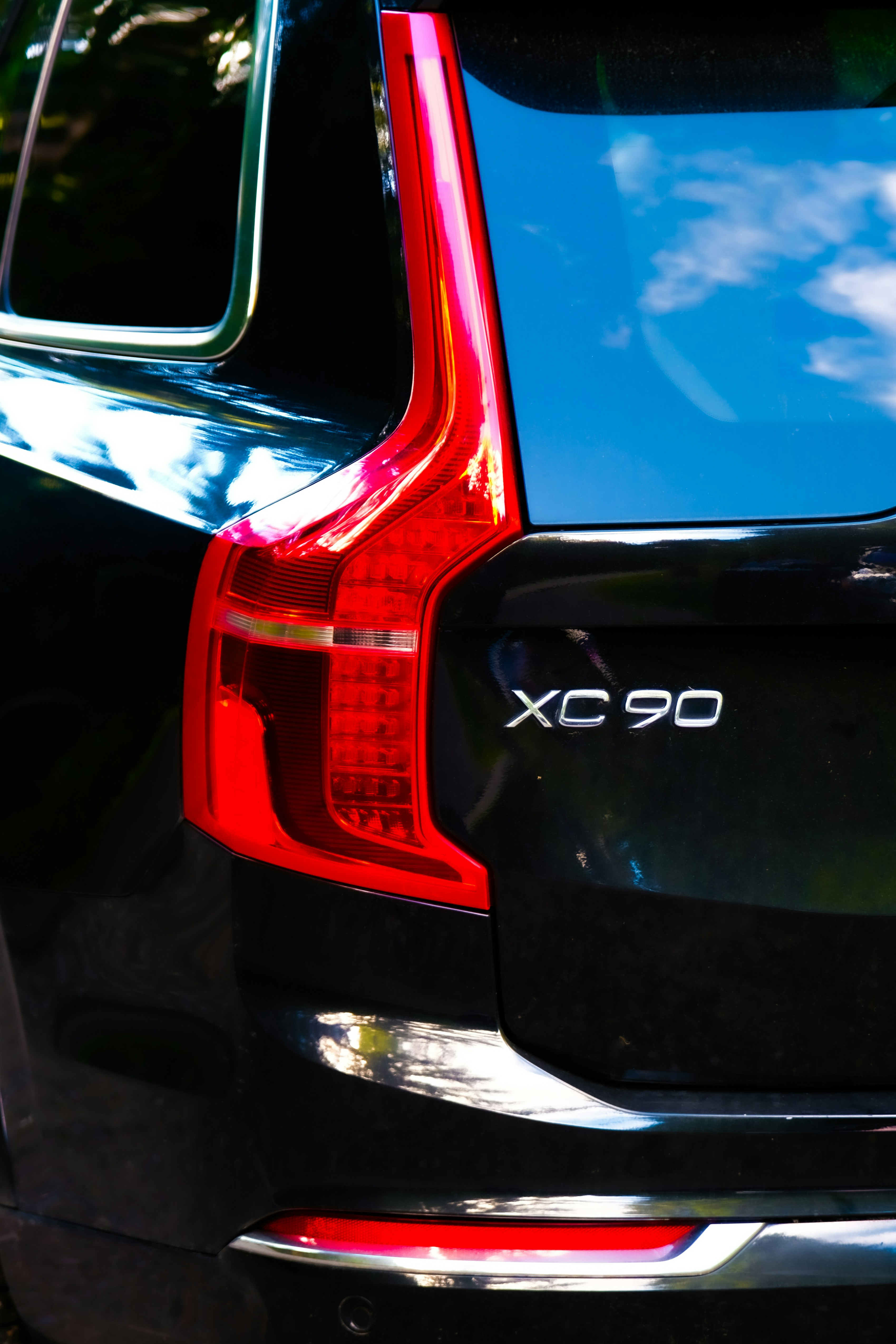 Rear detail of a black volvo xc90 suv.
