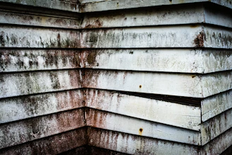 Weathered wooden siding with streaks of dirt.