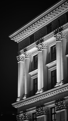 Ornate building facade with columns at night