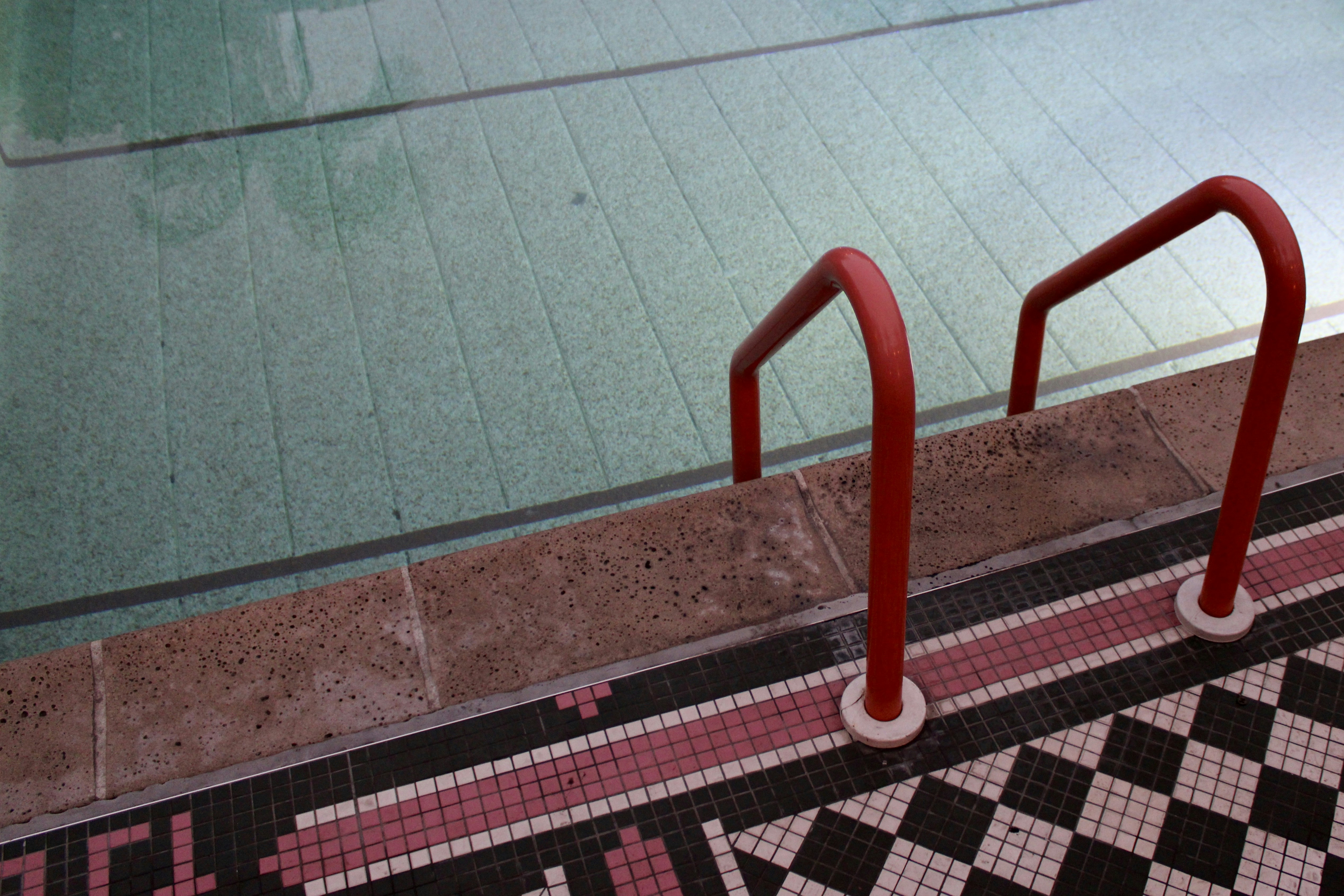 Red ladder leads into pool