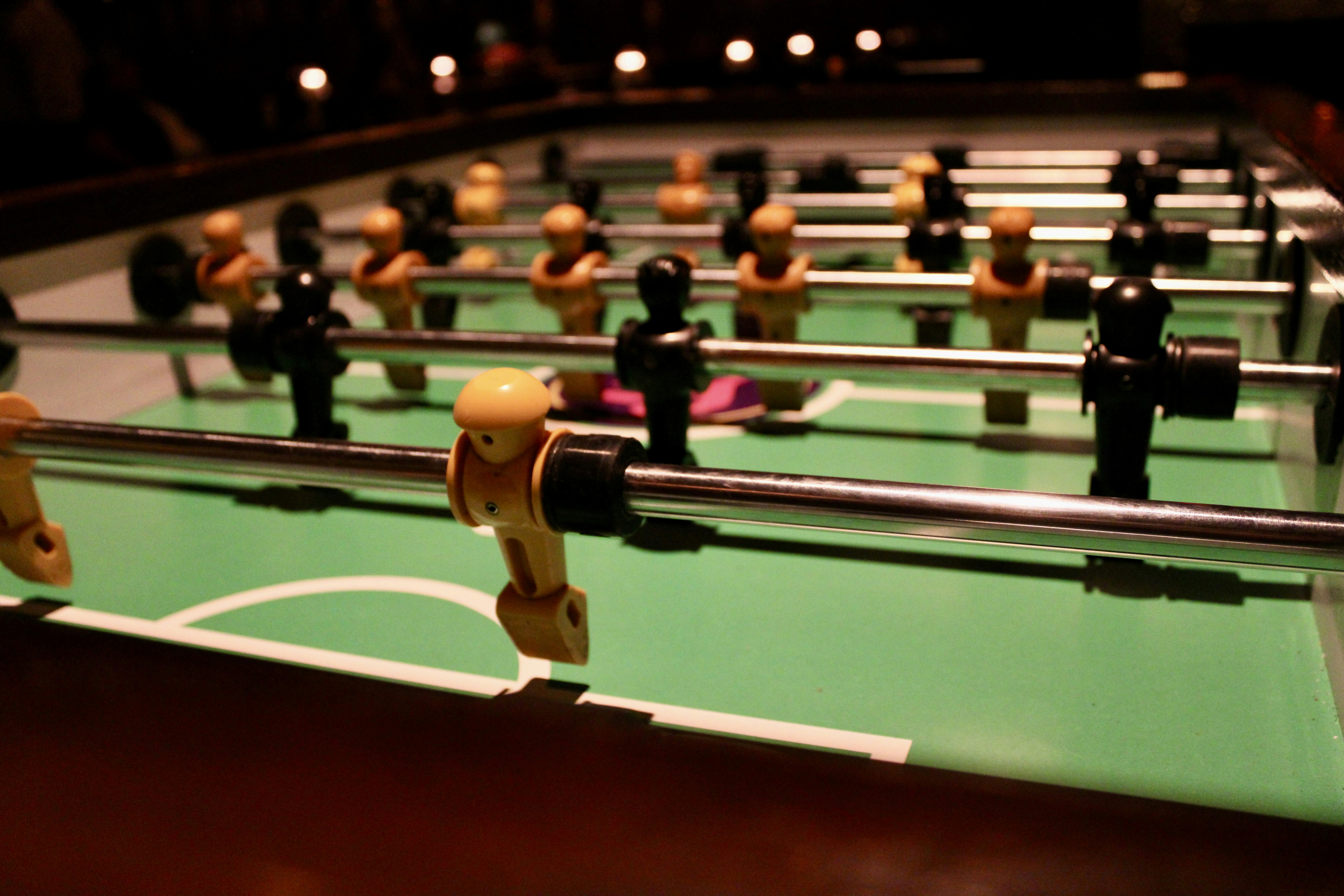 Foosball players on a green table field