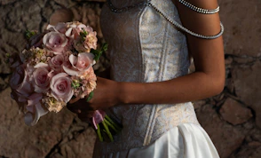 Bride holding a bouquet of pink roses