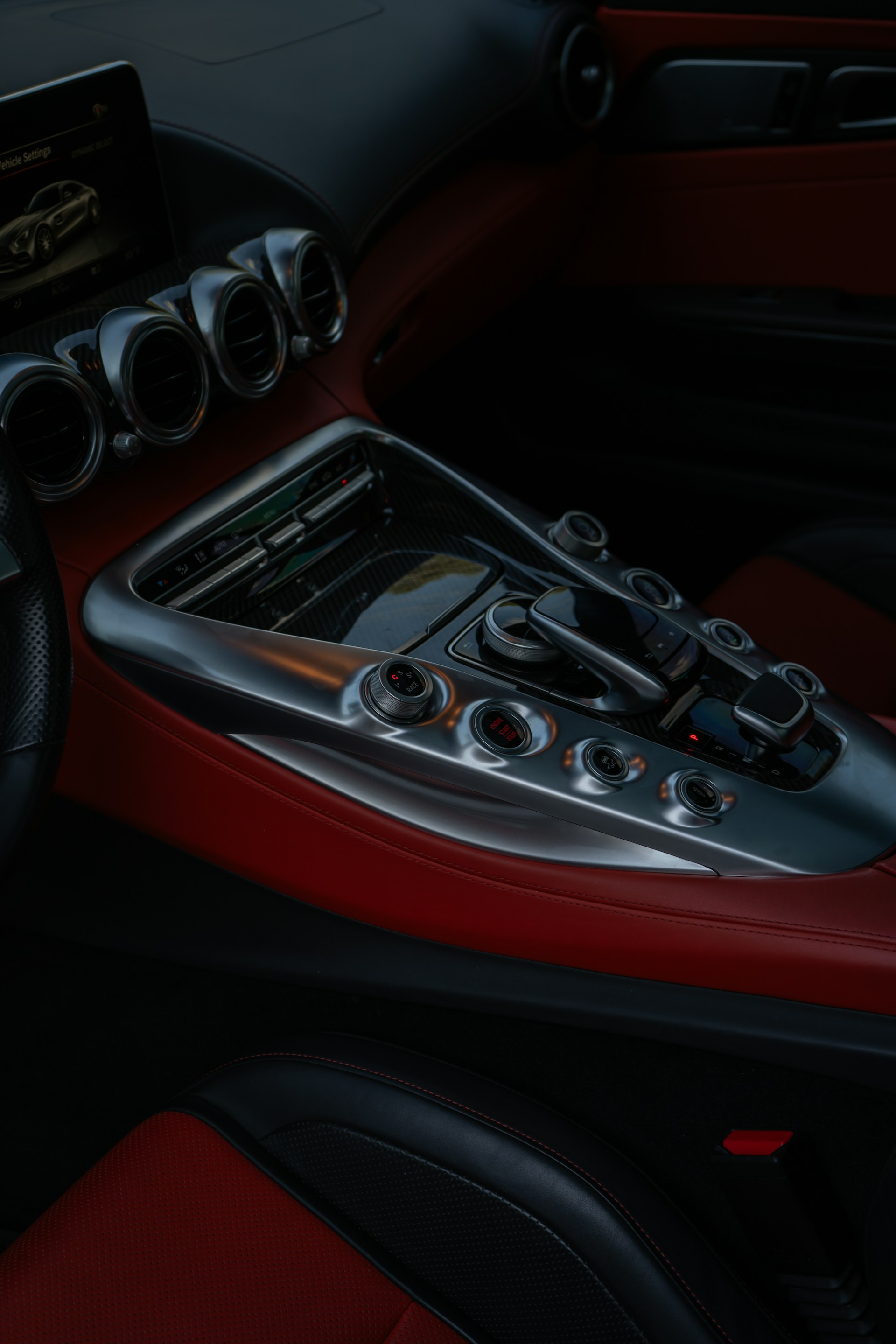Luxury car interior with red leather accents.