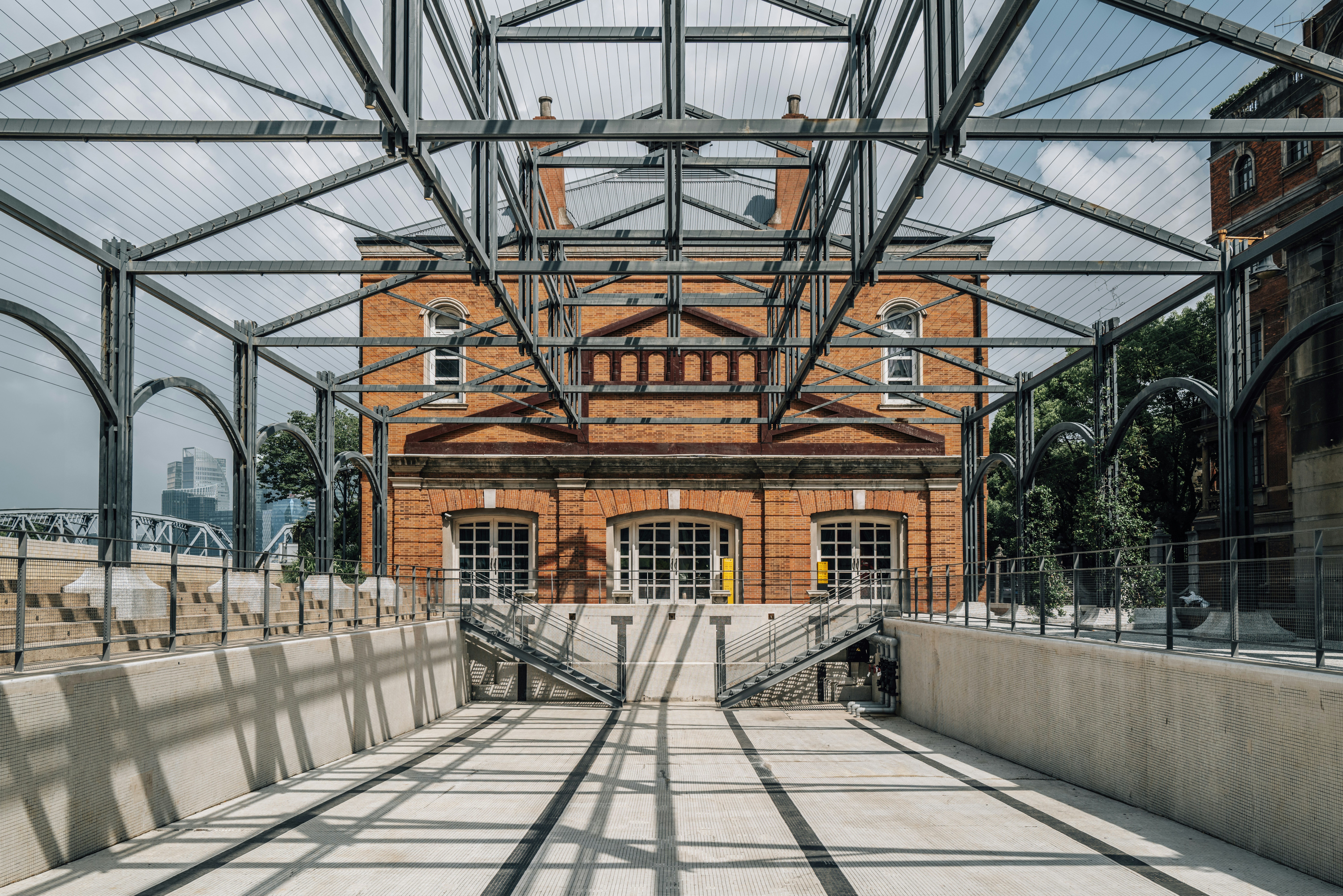 Ornate brick building framed by industrial metal structure