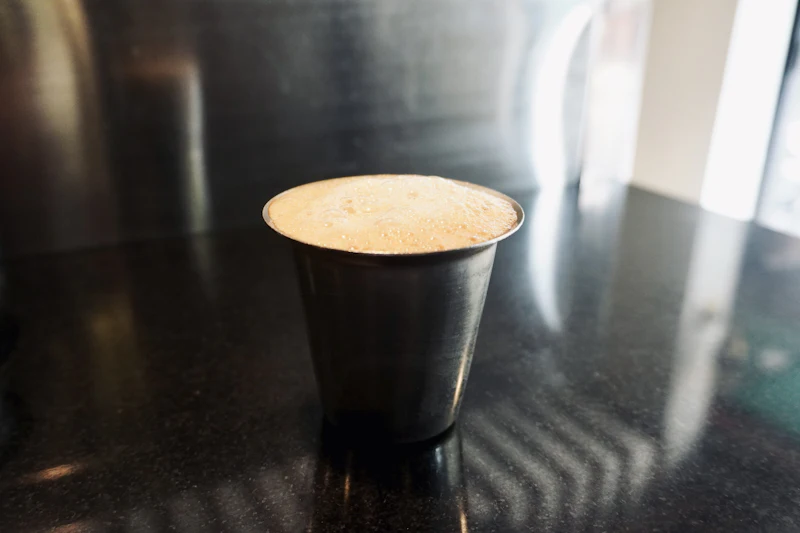 South Indian filter coffee in a steel tumbler and davara