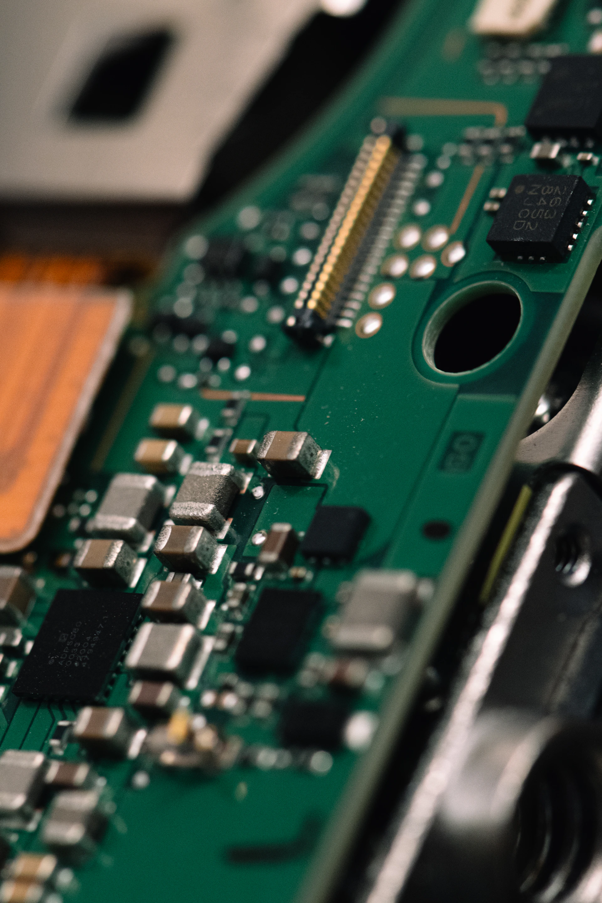 Close-up of a green circuit board with electronic components.