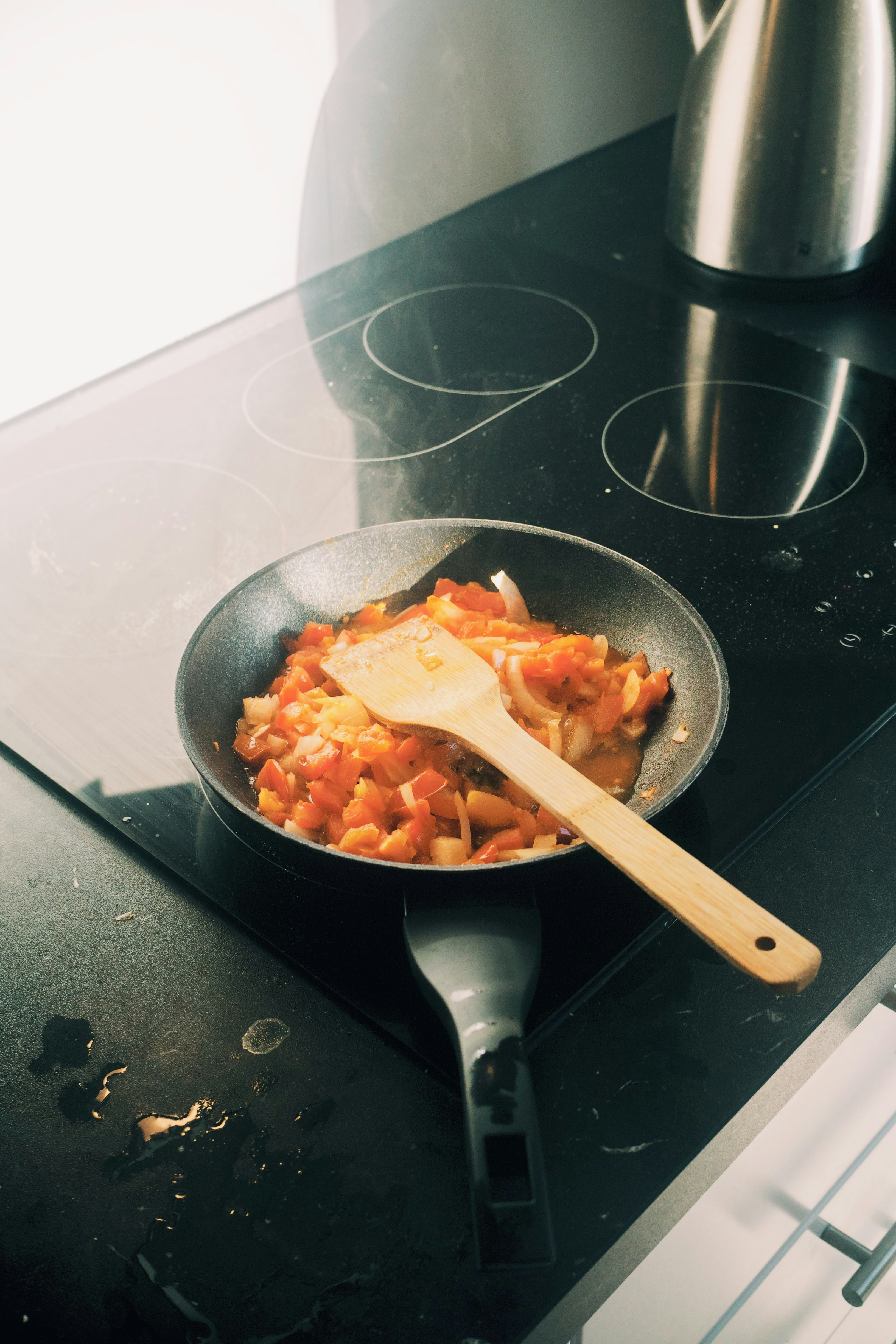 Chopped tomatoes and onions cooking in a pan