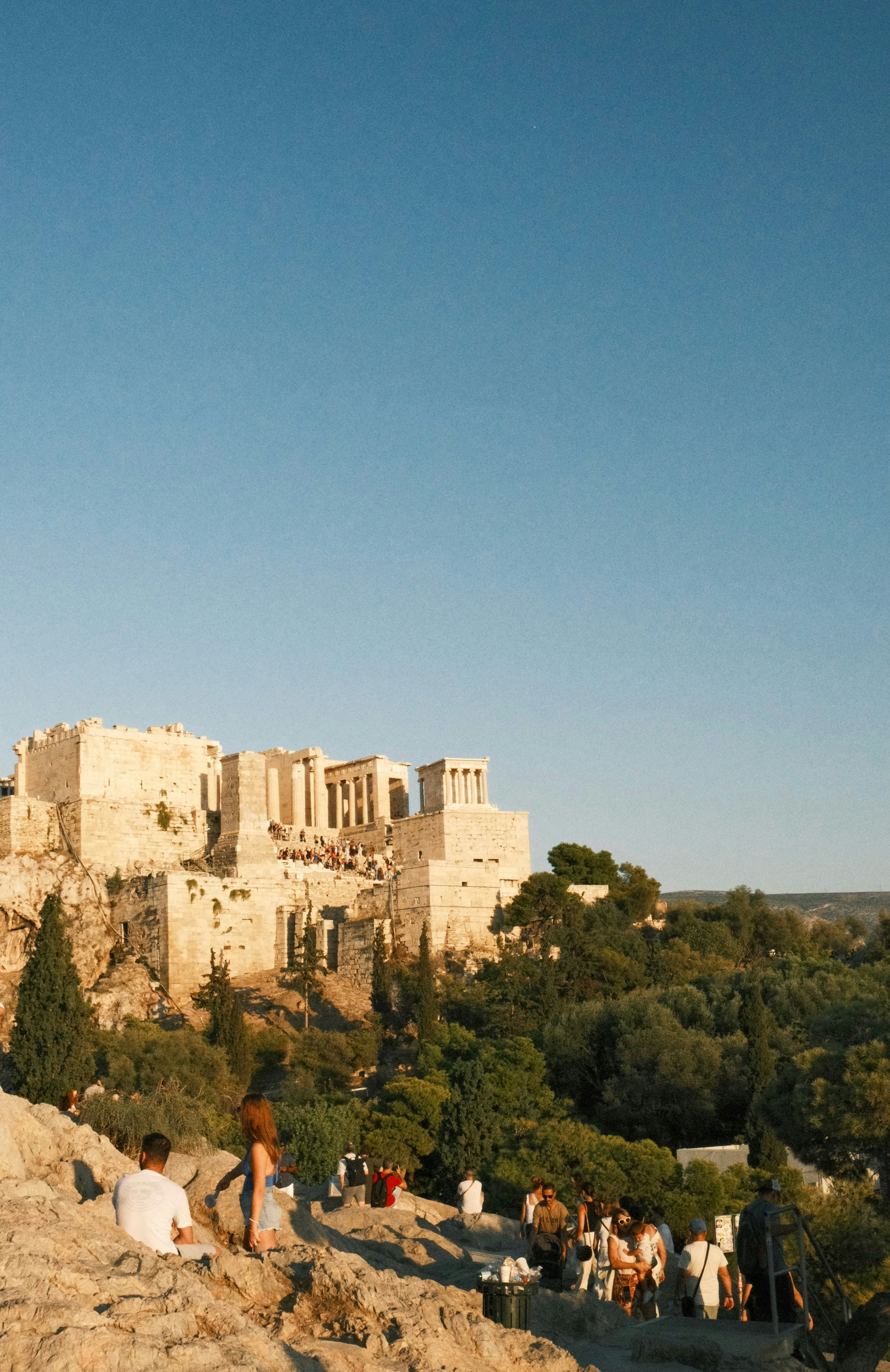 Ancient ruins on a hill with people below