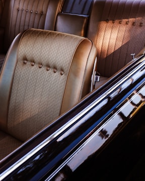 Interior of a classic car with tan seats.