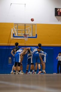 Basketball team huddling before the game starts.