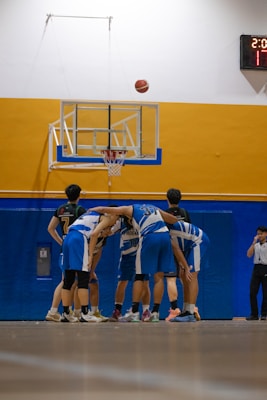 Basketball team huddling before the game starts.
